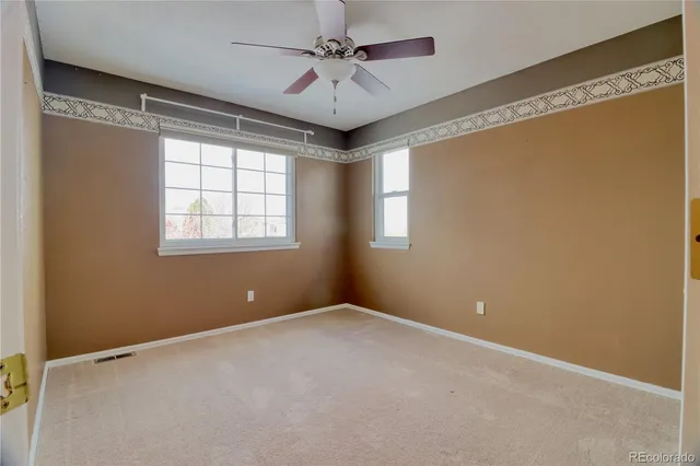 a view of room with window and ceiling fan