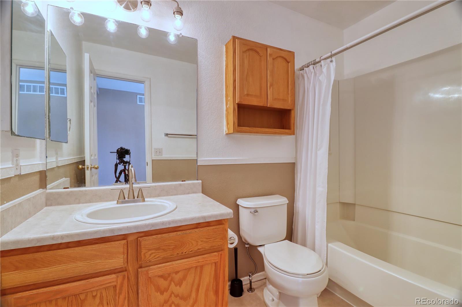 3819 South Rome Way Aurora, CO 80018 - Photo 20 of 32 a bathroom with a sink toilet and shower