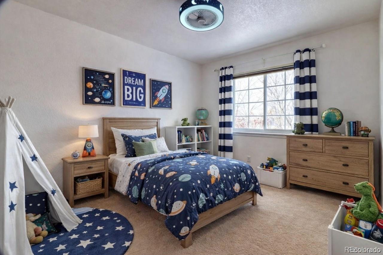 3819 South Rome Way Aurora, CO 80018 - Photo 25 of 32 a bedroom with a bed and a window
