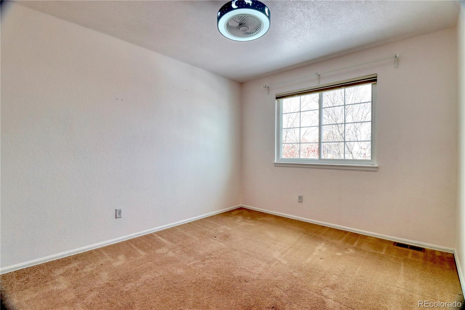 3819 South Rome Way Aurora, CO 80018 - Photo 26 of 32 an empty room with a empty space and windows