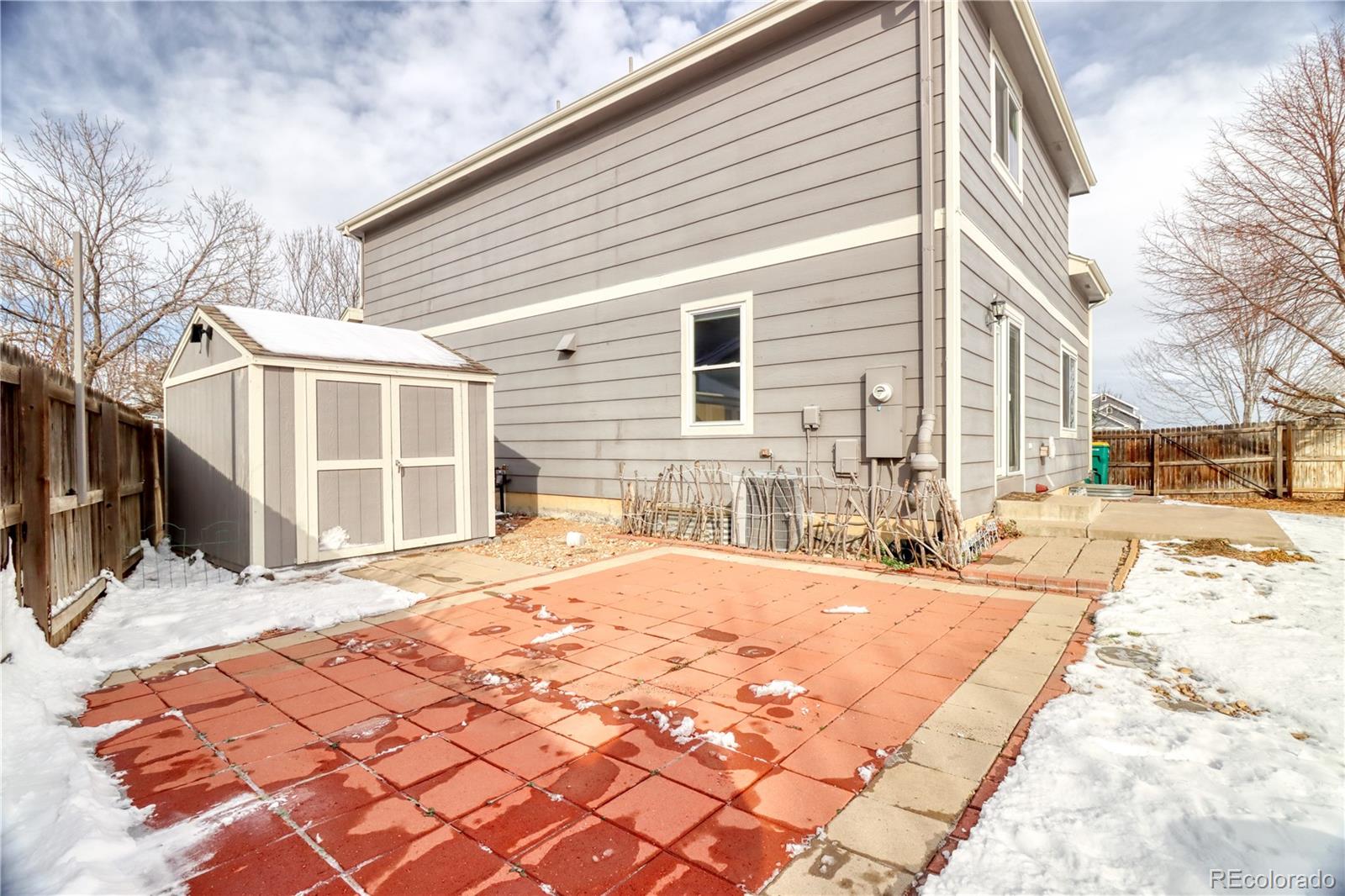 3819 South Rome Way Aurora, CO 80018 - Photo 30 of 32 a front view of a house with a yard