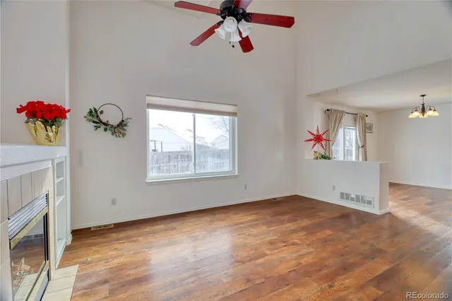 a view of an empty room with a ceiling fan and a window