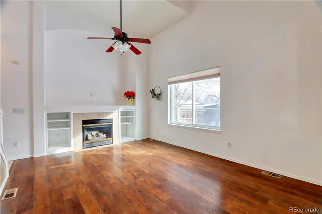a view of a livingroom with a fireplace and a window