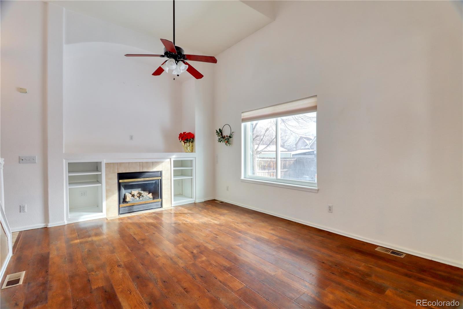 3819 South Rome Way Aurora, CO 80018 - Photo 4 of 25 a view of a livingroom with a fireplace and a window