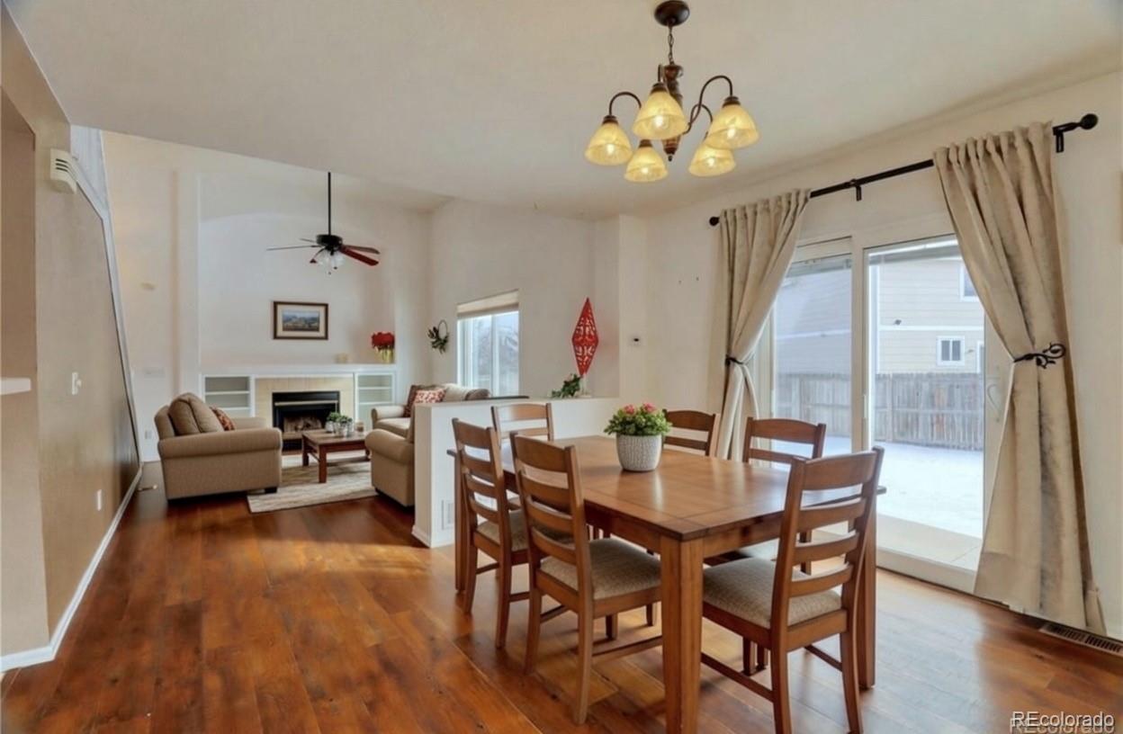 3819 South Rome Way Aurora, CO 80018 - Photo 5 of 32 a view of a dining room with furniture window and wooden floor
