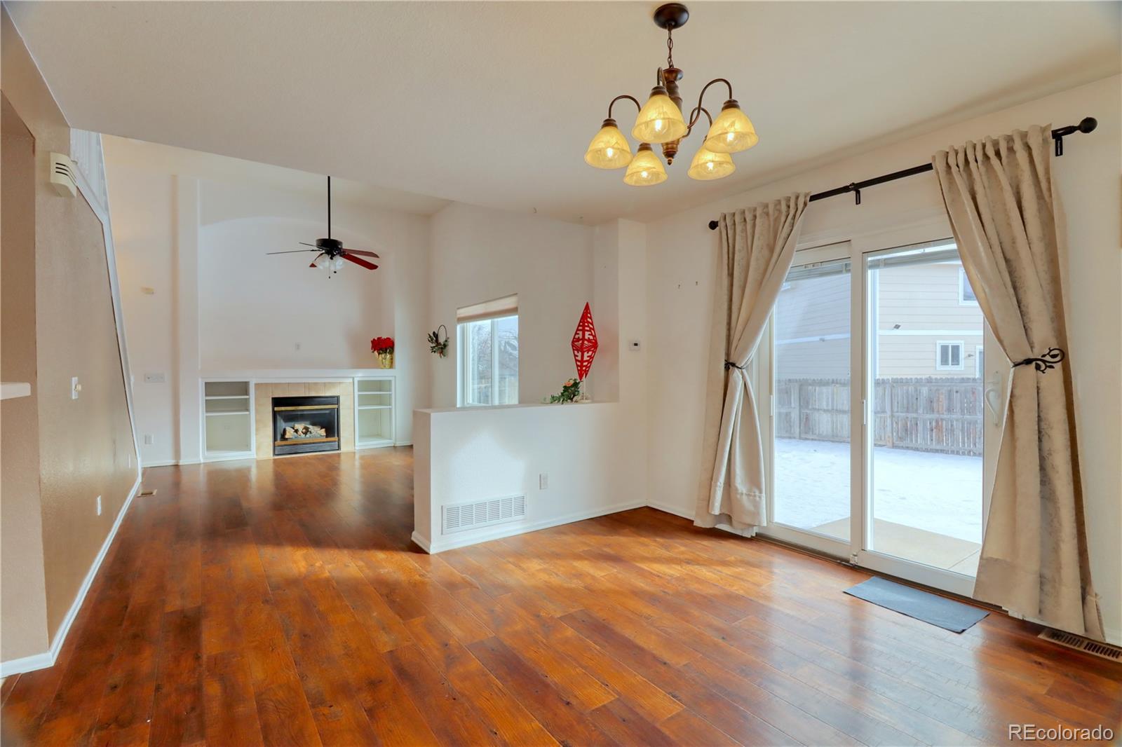 3819 South Rome Way Aurora, CO 80018 - Photo 6 of 25 wooden floor in an empty room with a window