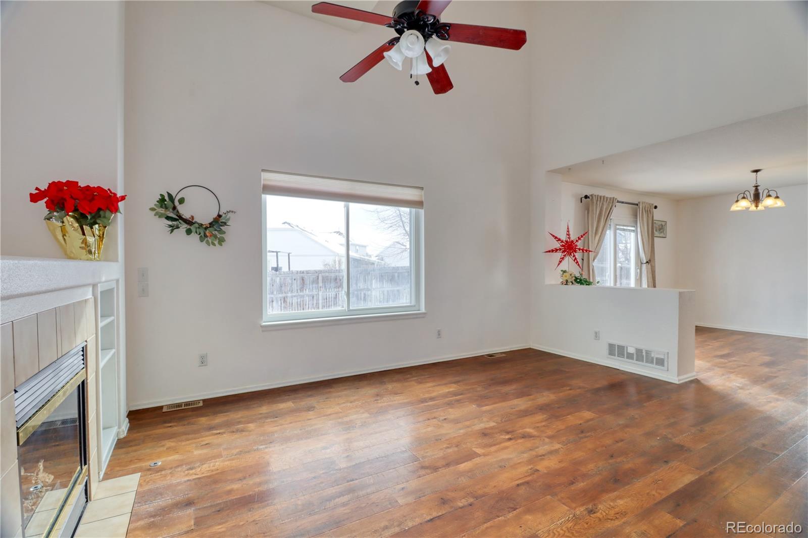 3819 South Rome Way Aurora, CO 80018 - Photo 6 of 32 a view of an empty room with a ceiling fan and a window