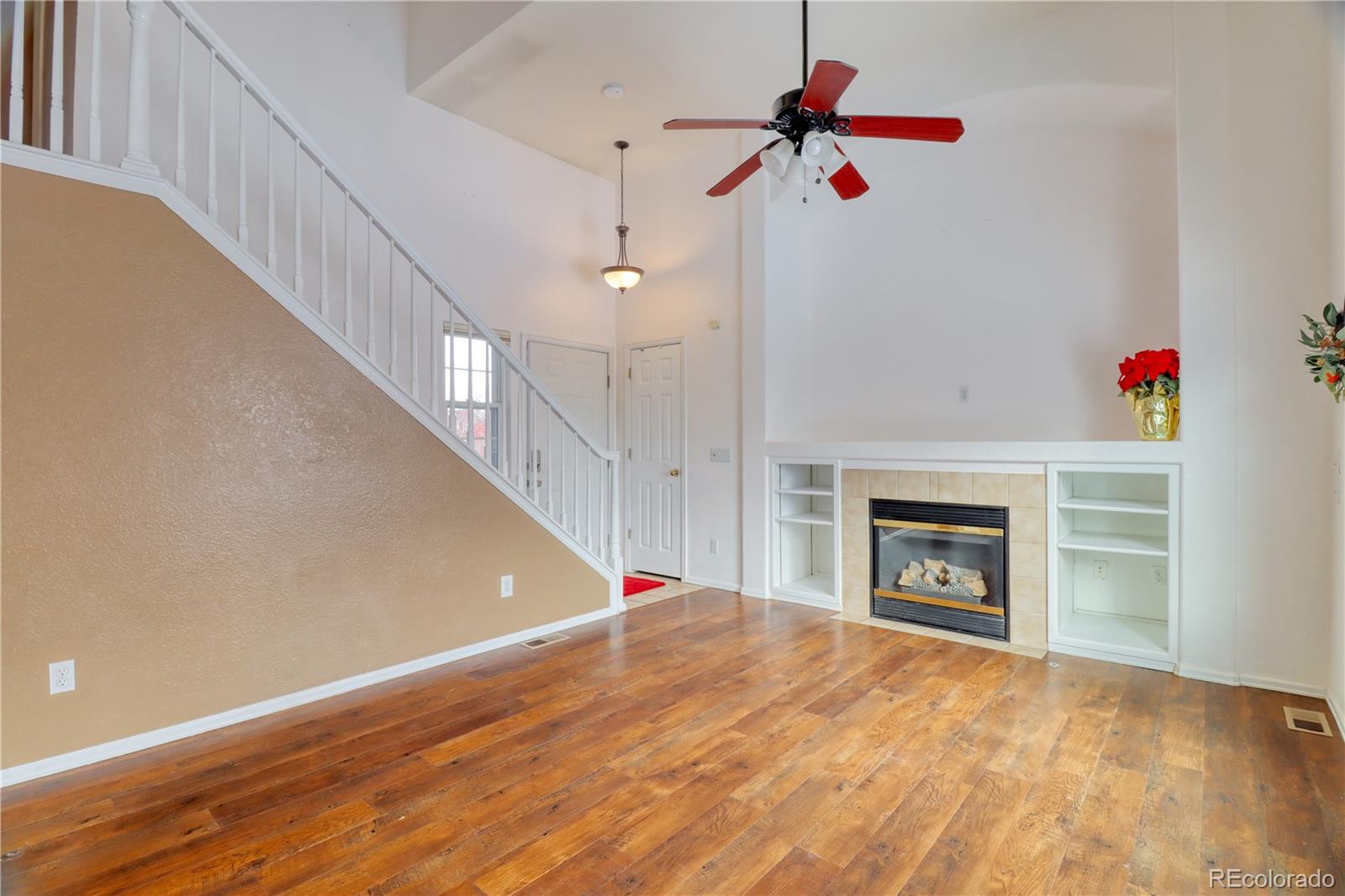 3819 South Rome Way Aurora, CO 80018 - Photo 7 of 25 a view of empty room with fireplace and fan
