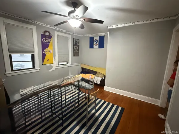 a living room with a bed furniture and a window