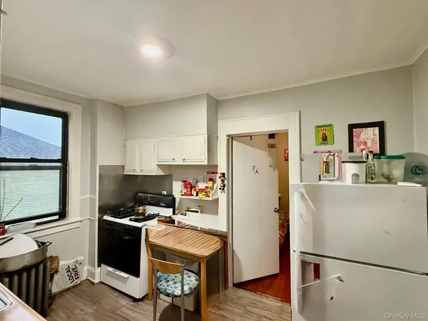 a room with refrigerator and cabinets