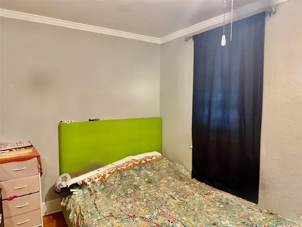 a bedroom with a bed and green walls