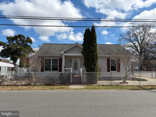 a front view of a house with a yard and a garage