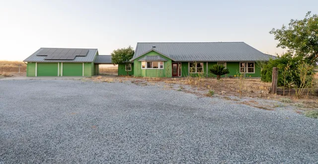 a front view of a house with yard and a garage