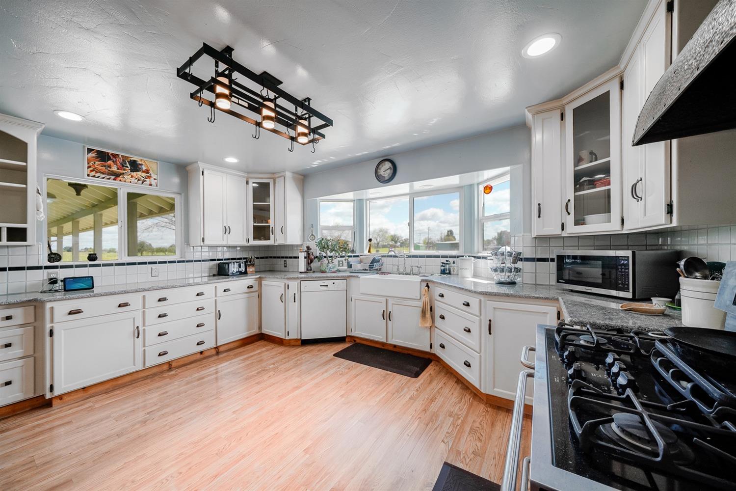 37491 Verde Avenue Madera, CA 93636 - Photo 11 of 66 a kitchen with stainless steel appliances white cabinets a stove a sink and a refrigerator