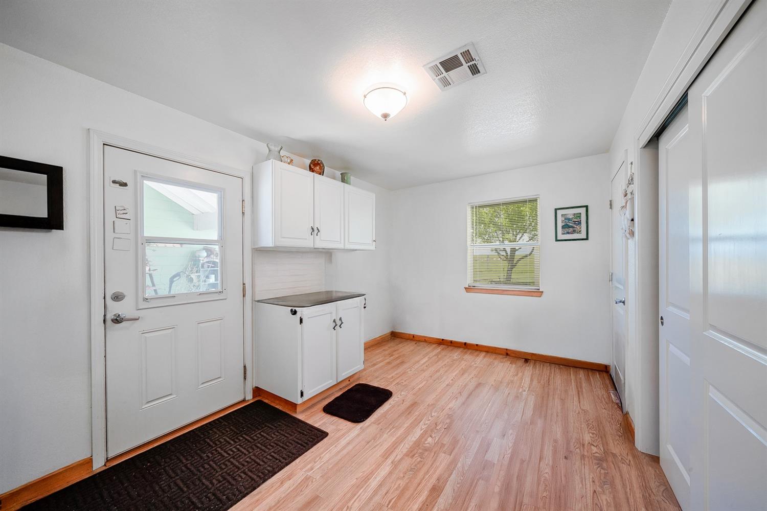 37491 Verde Avenue Madera, CA 93636 - Photo 12 of 66 a view of kitchen with wooden floor electronic appliances and window