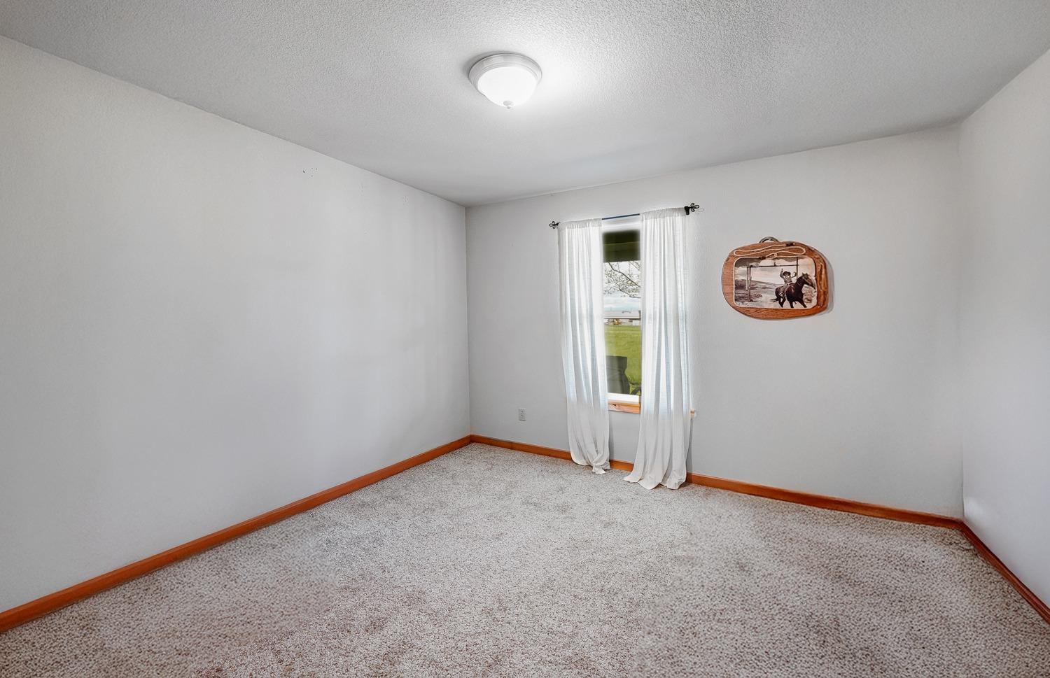 37491 Verde Avenue Madera, CA 93636 - Photo 16 of 66 an empty room with windows