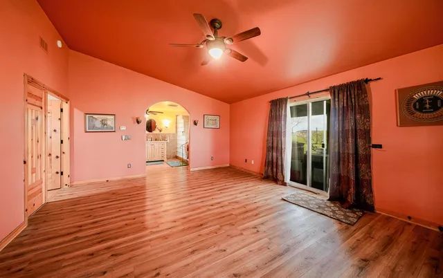a view of a livingroom with furniture and floor to ceiling window