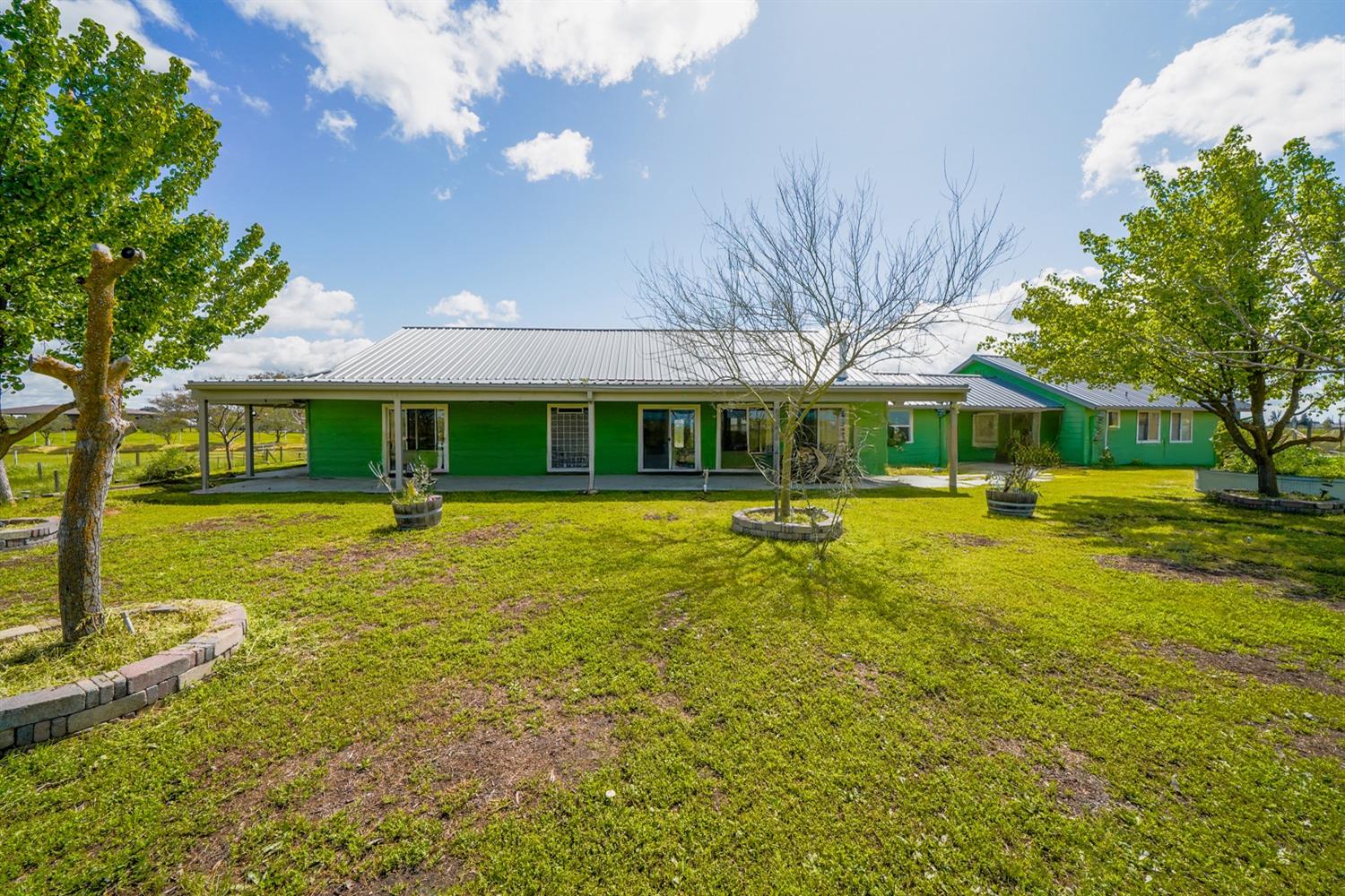 37491 Verde Avenue Madera, CA 93636 - Photo 28 of 66 a front view of a house with garden