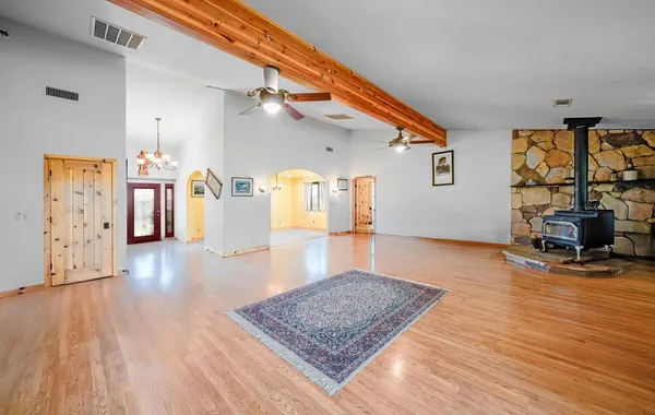 a living room with furniture and a wooden floor