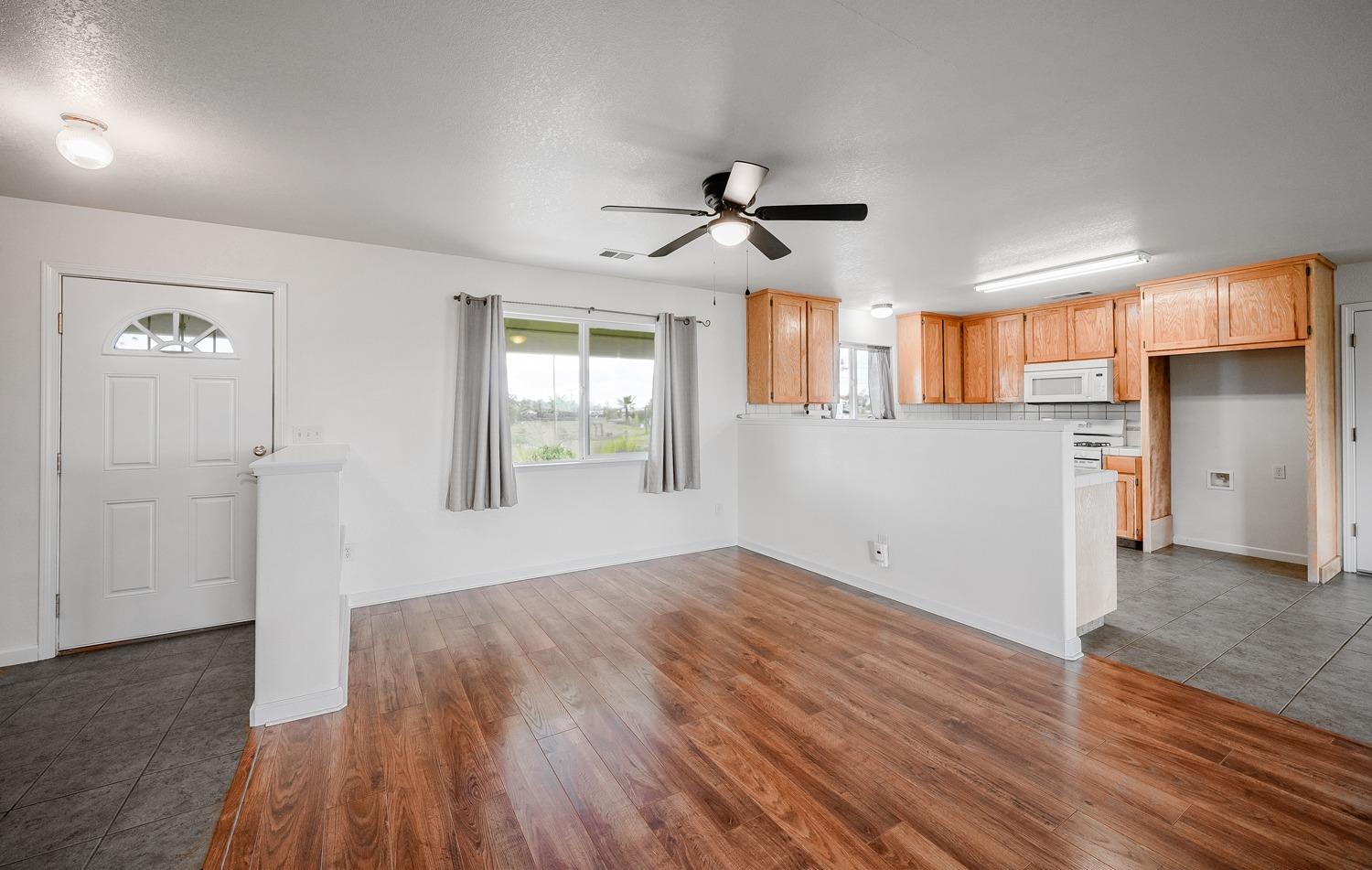 37491 Verde Avenue Madera, CA 93636 - Photo 38 of 66 a view of empty room with wooden floor and window