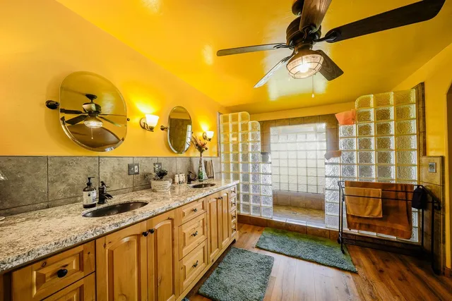 a bathroom with a granite countertop sink and a mirror