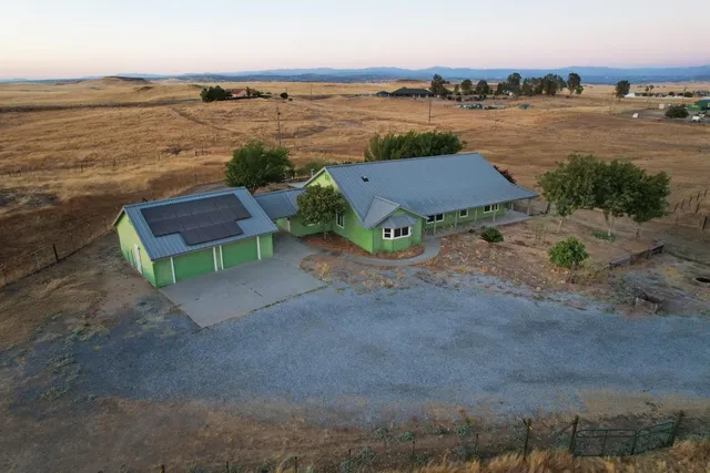 a view of a workspace with wooden floor and a window