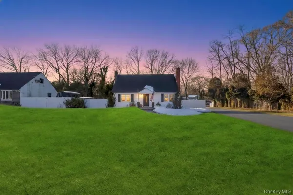 a view of a house with backyard and a sitting area