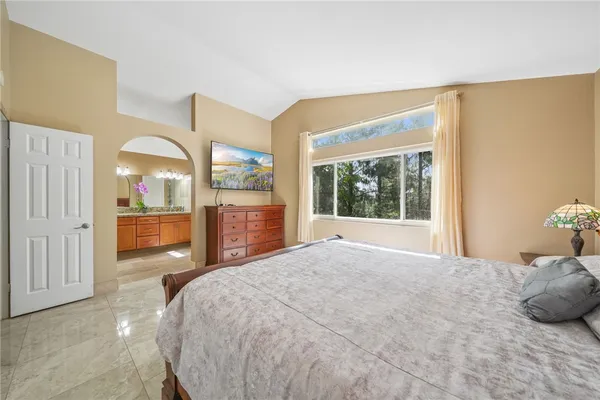 a bedroom with a large bed and a large window