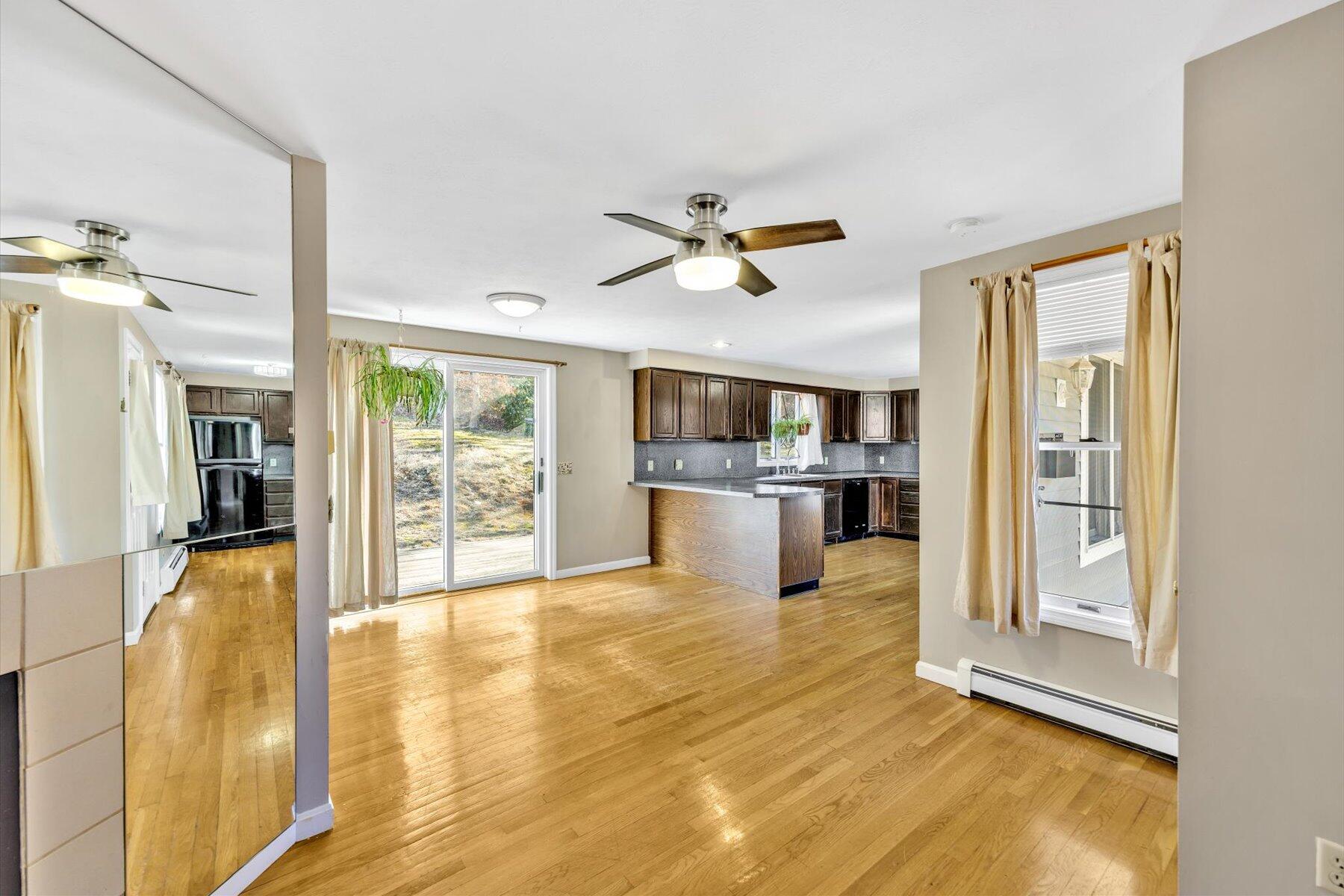 171 Currier Road East Falmouth, MA 02536 - Photo 11 of 47 a view of an empty room with kitchen view and a window