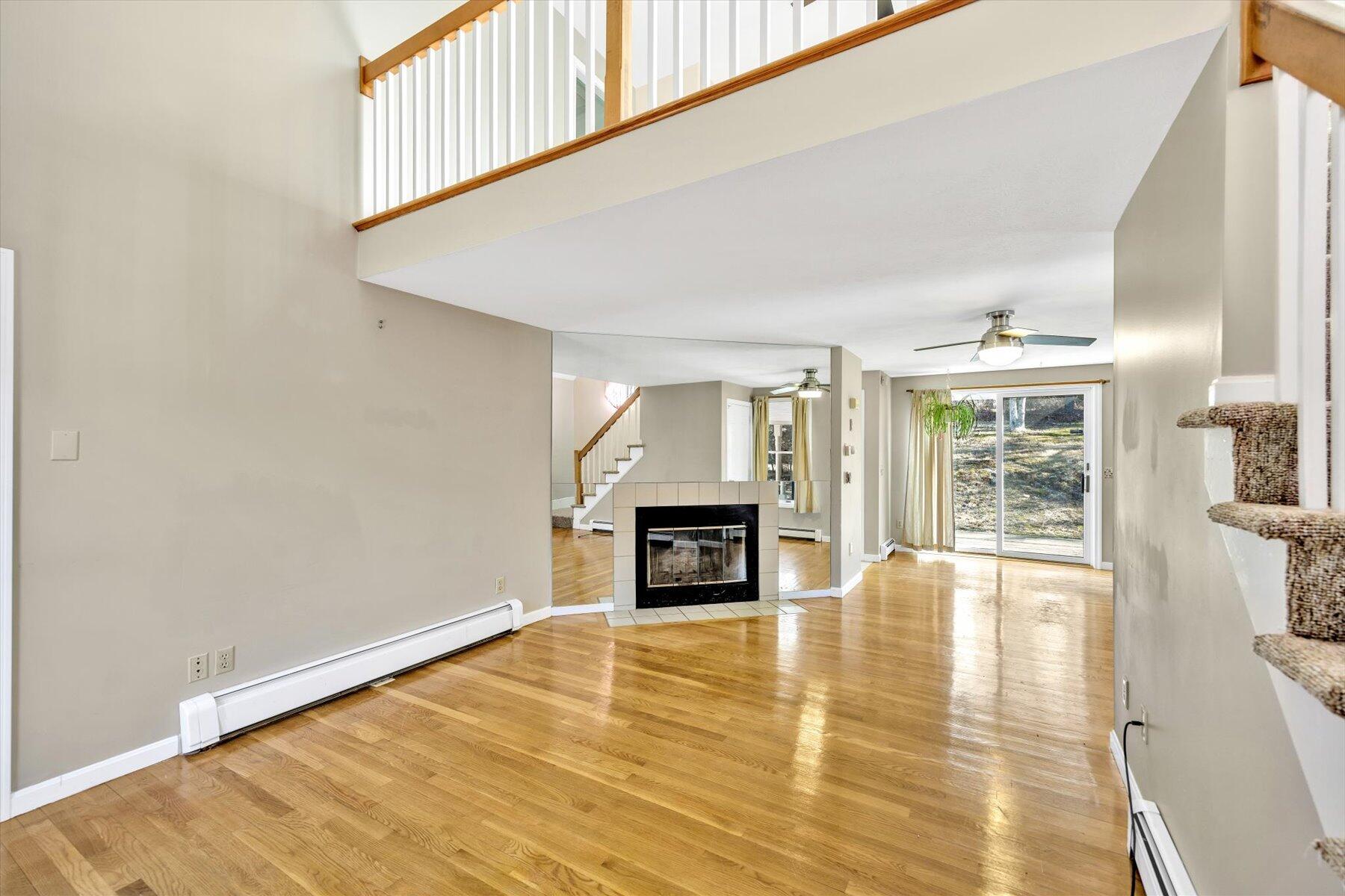 171 Currier Road East Falmouth, MA 02536 - Photo 12 of 47 a view of an empty room with window and fire place