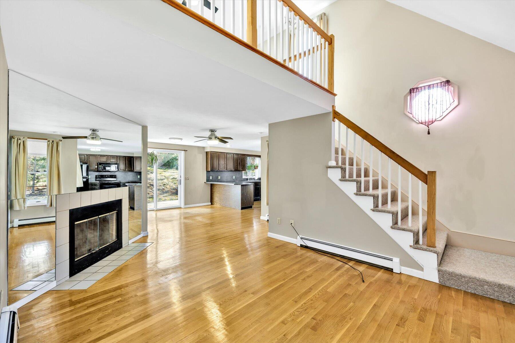 171 Currier Road East Falmouth, MA 02536 - Photo 13 of 47 a view of a livingroom with wooden floor and a fireplace