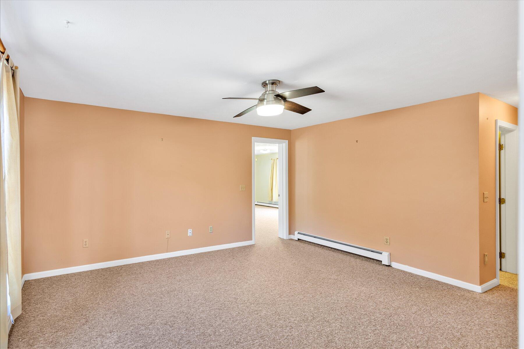 171 Currier Road East Falmouth, MA 02536 - Photo 19 of 47 an empty room with a window and a fan