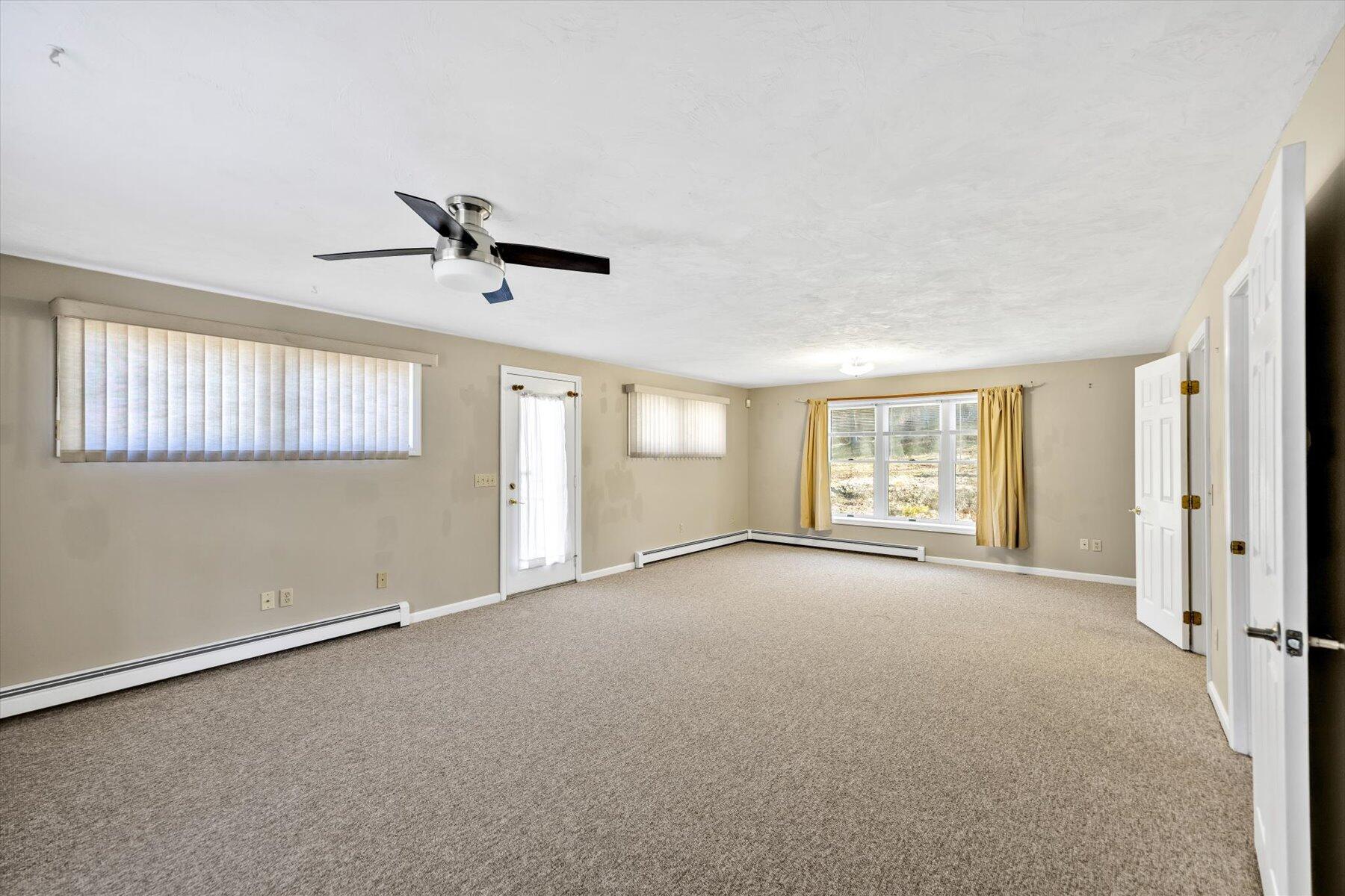 171 Currier Road East Falmouth, MA 02536 - Photo 22 of 47 a view of a livingroom with a ceiling fan and window