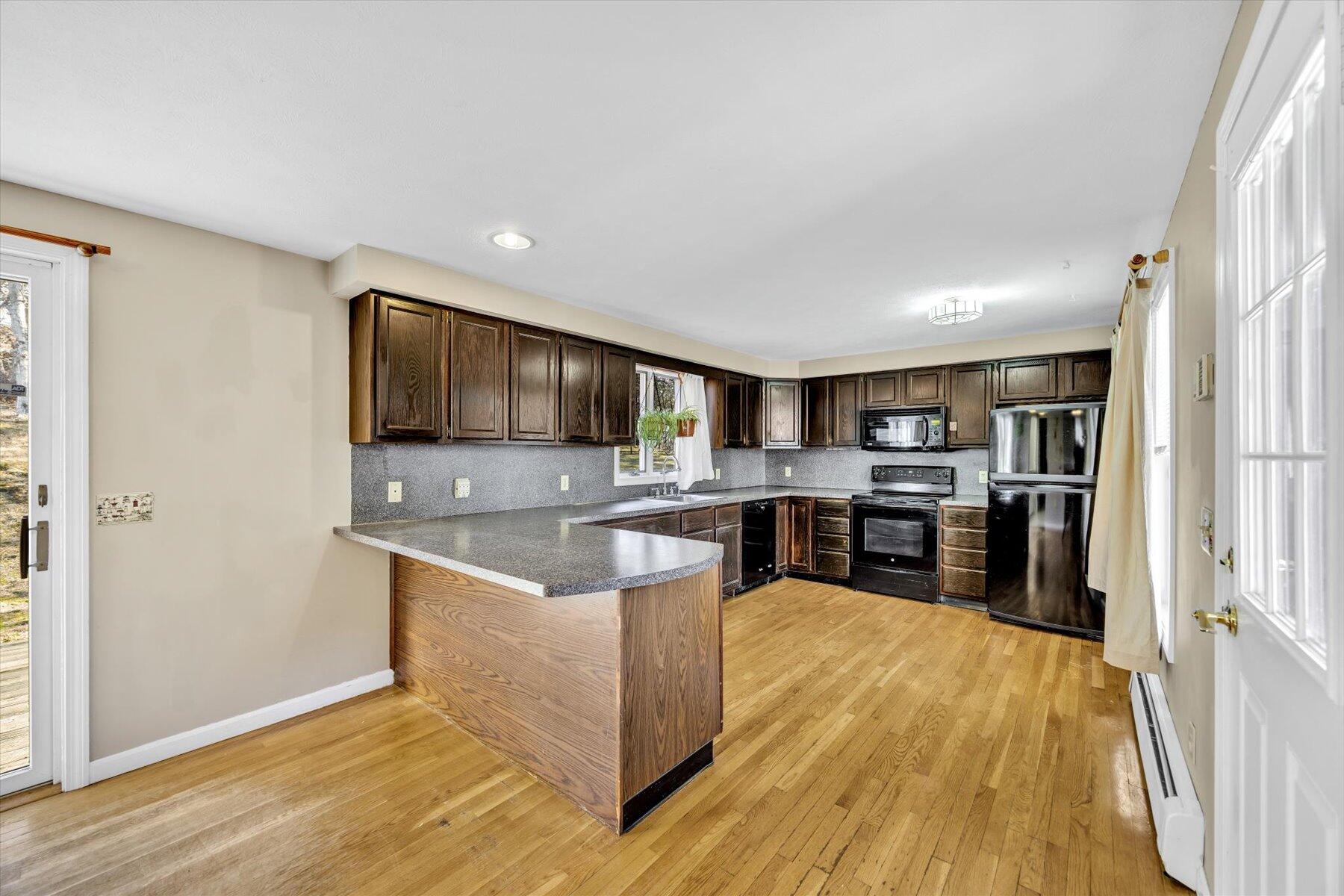171 Currier Road East Falmouth, MA 02536 - Photo 3 of 47 a kitchen with stainless steel appliances granite countertop a refrigerator and a stove top oven
