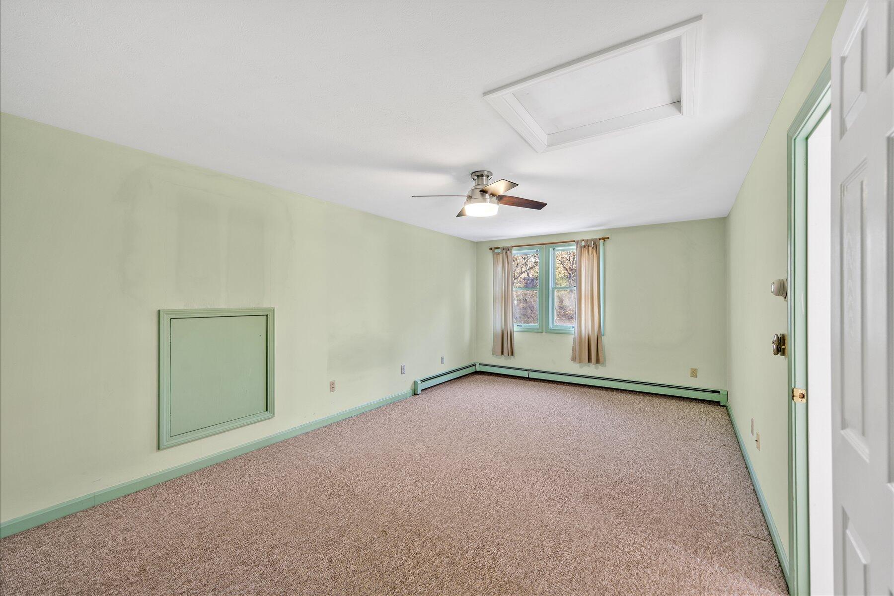 171 Currier Road East Falmouth, MA 02536 - Photo 32 of 47 an empty room with chandelier fan and windows