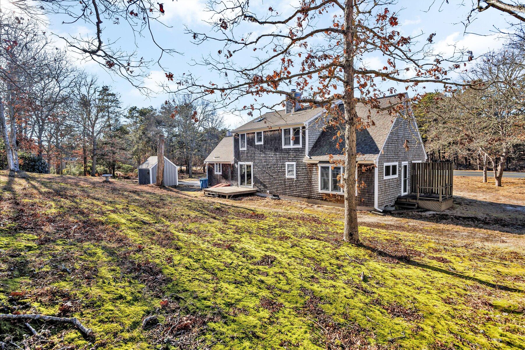 171 Currier Road East Falmouth, MA 02536 - Photo 39 of 47 a front view of a house with a yard covered with snow