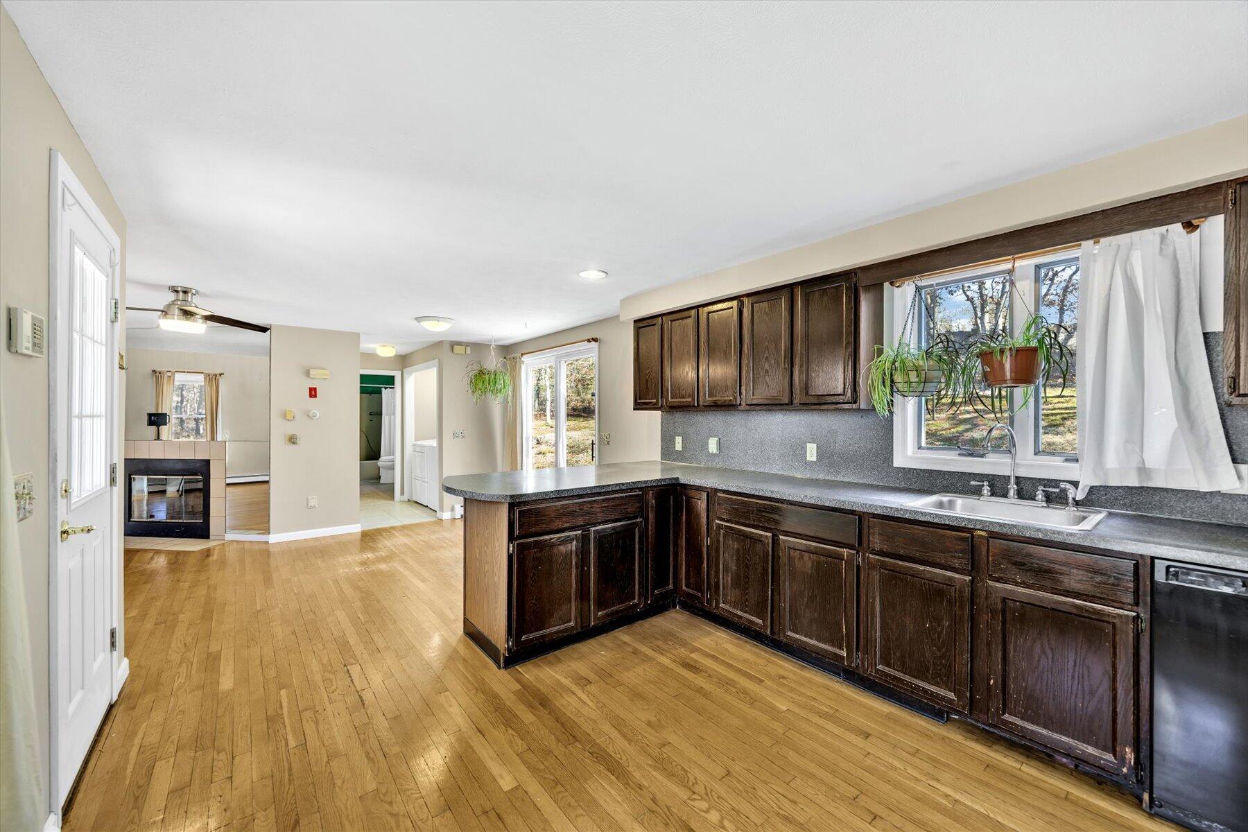 171 Currier Road East Falmouth, MA 02536 - Photo 6 of 47 a large kitchen with wooden floors and stainless steel appliances