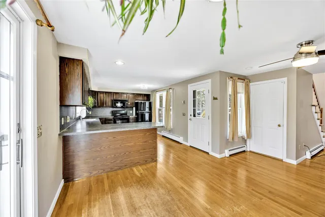 a view of living room with furniture and wooden floor