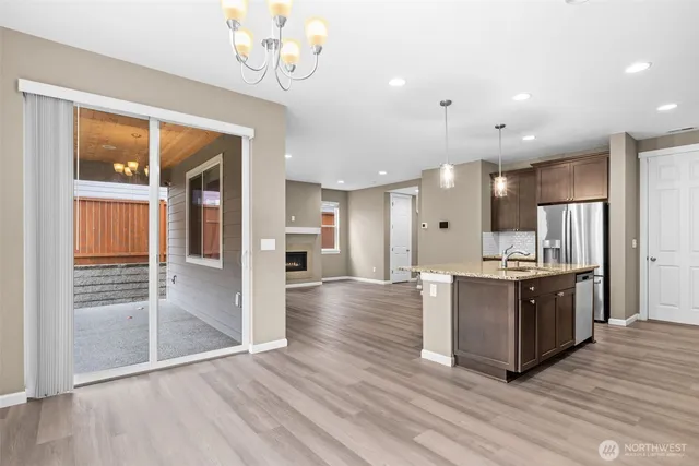 a large kitchen with stainless steel appliances lots of counter space and wooden floor