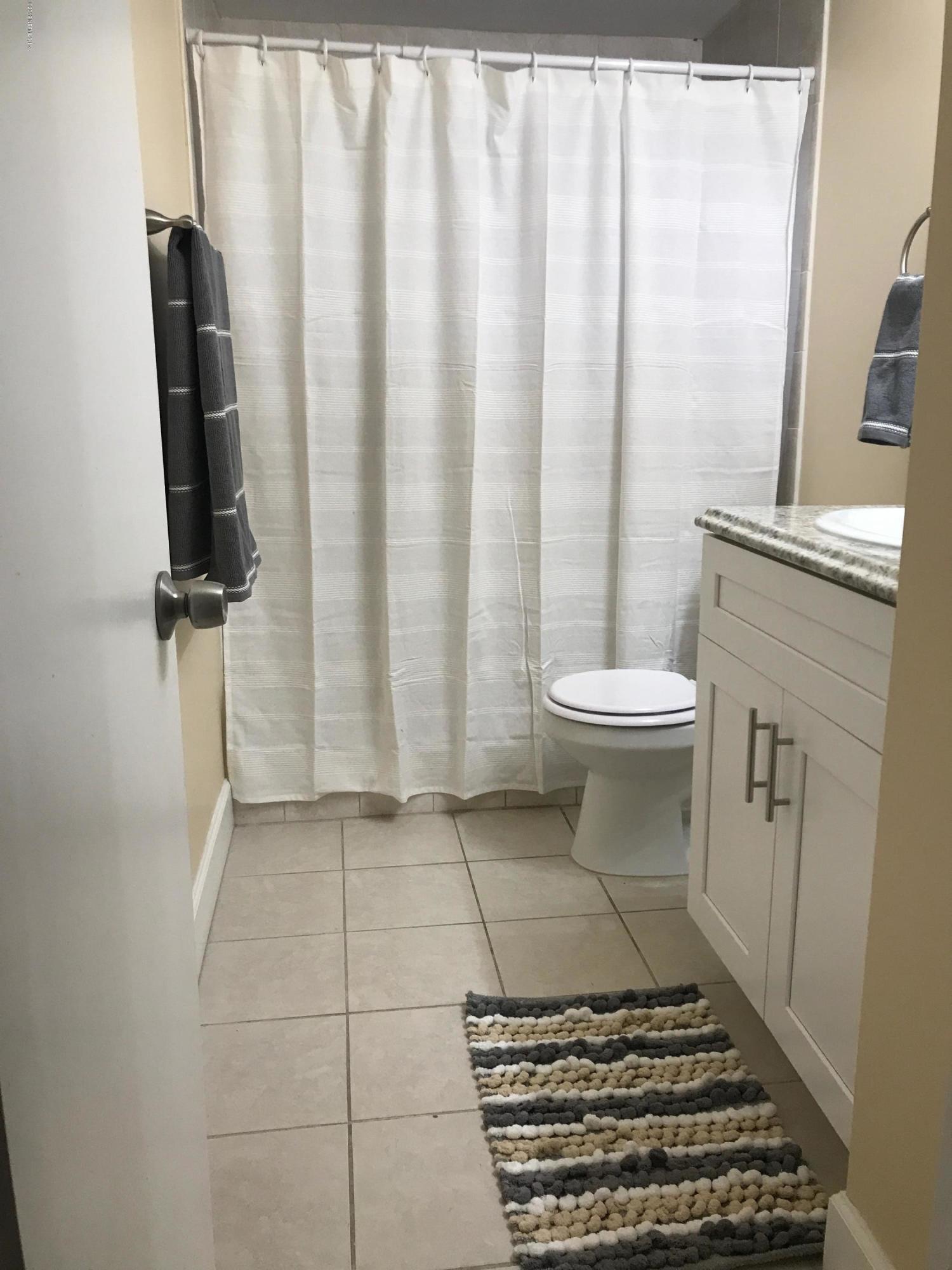 5626 Ricker Road Jacksonville, FL 32244 - Photo 18 of 25 a bathroom with a sink toilet and shower