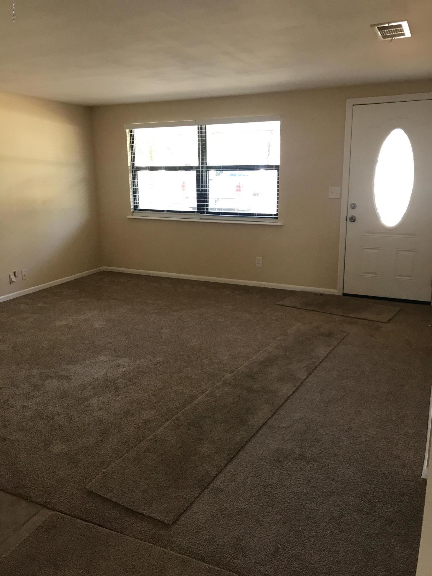 5626 Ricker Road Jacksonville, FL 32244 - Photo 7 of 25 an empty room with a window