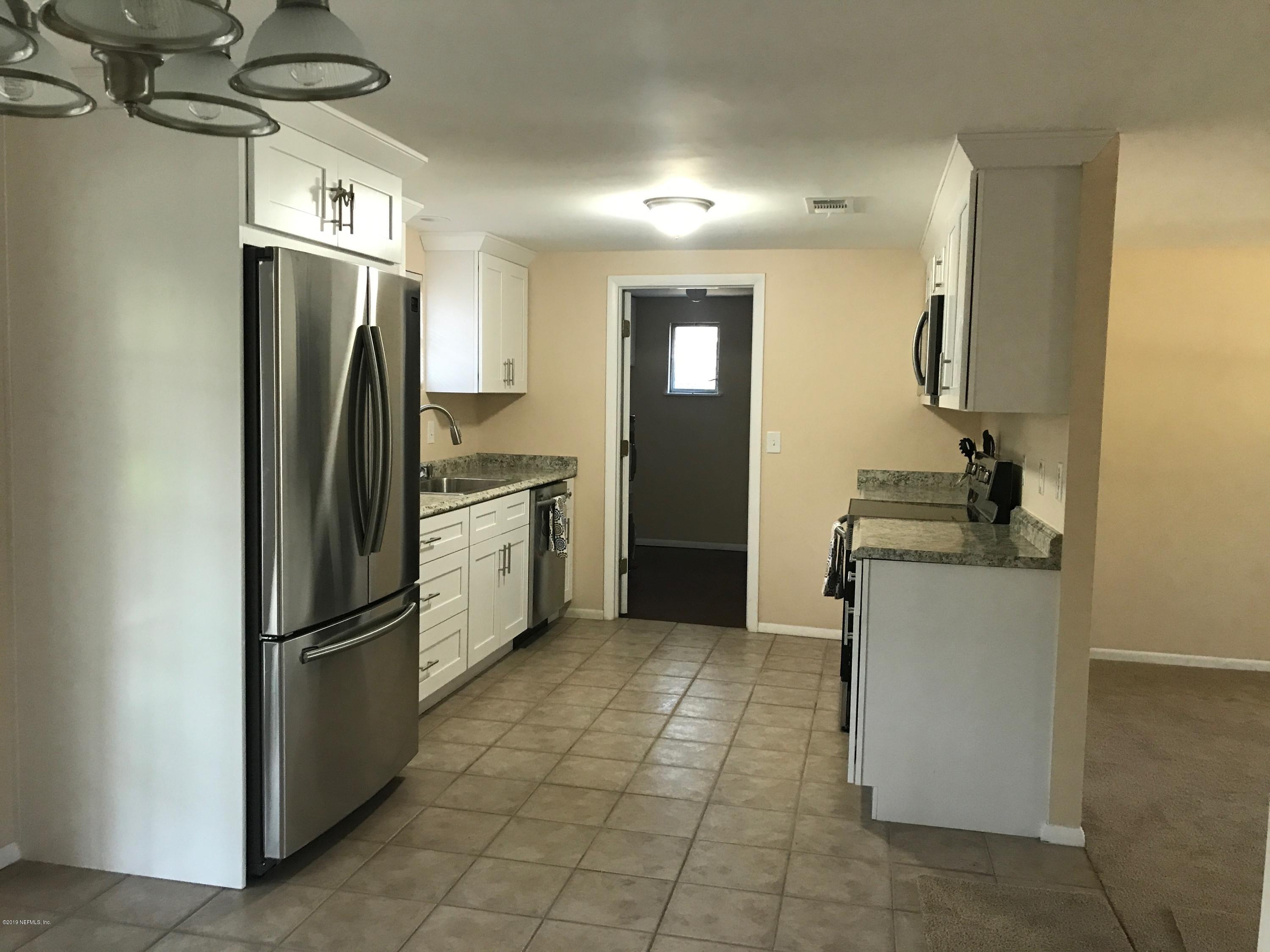 5626 Ricker Road Jacksonville, FL 32244 - Photo 8 of 25 a kitchen with stainless steel appliances granite countertop a refrigerator and a sink