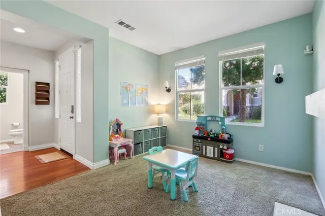 a living room with furniture a window and a potted plant