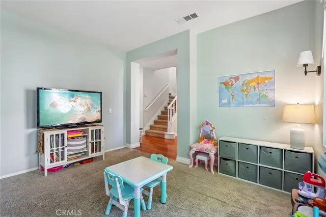 a living room with furniture a flat screen tv and a flat screen tv