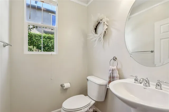 a white toilet sitting next to a bathroom sink