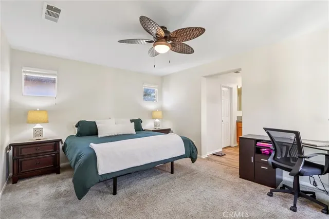 a bedroom with a bed a furniture and a chandelier