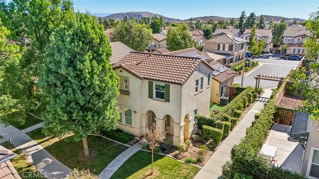 an aerial view of a house with a yard