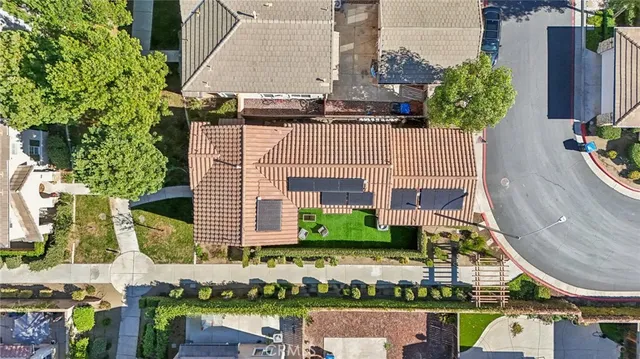 an aerial view of a house with a yard and potted plants