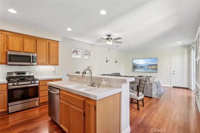 a kitchen with a sink cabinets and wooden floor