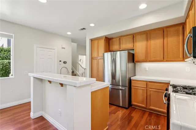 a kitchen with a refrigerator sink and stove